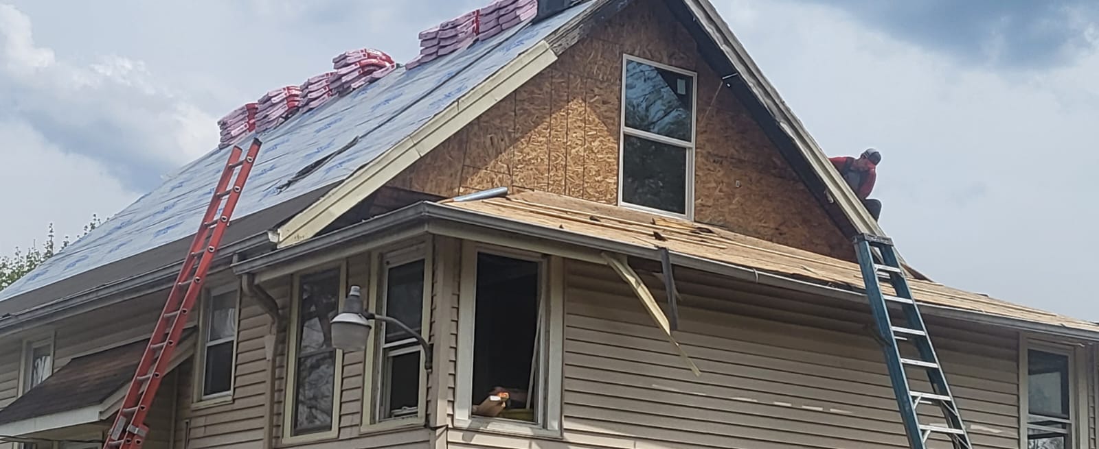 New roof decking and gable sheathing installed during a roof replacement